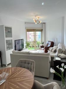 a living room with two couches and a television at Fuengirola, Doña Sofia amazing sea view in Fuengirola
