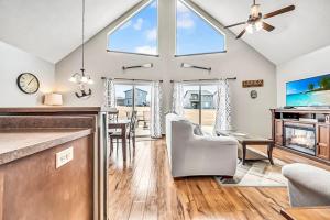 a kitchen and dining room with a ceiling fan at The Anchor Poolside at Bridges Bay Resort in Arnolds Park