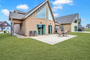a home with a patio and a house at The Anchor Poolside at Bridges Bay Resort in Arnolds Park