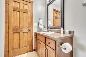 a bathroom with a sink and a mirror at The Anchor Poolside at Bridges Bay Resort in Arnolds Park +27 photos