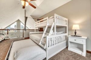 a bedroom with a white bunk bed and a desk at The Anchor Poolside at Bridges Bay Resort in Arnolds Park