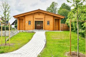 a log cabin with a walkway in front of it at Feriendorf Blauvogel Blauvogel 040 in Hasselfelde