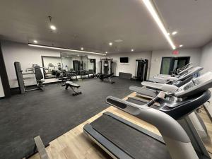 a gym with treadmills and machines in a room at Peaceful Midtown Apartment with Gym and Parking in Tulsa