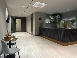 a lobby with a waiting area with chairs and a counter at The Roots Boutique Hotel in Shkodër