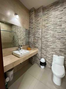 a bathroom with a white toilet and a sink at Casa Soly in Mazatlán +34 photos