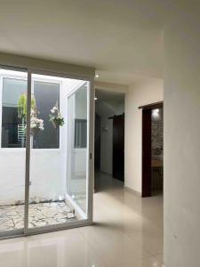 a room with a large glass door with a window at Casa Soly in Mazatlán