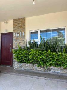 a house with a door and plants in front of it at Casa Soly in Mazatlán