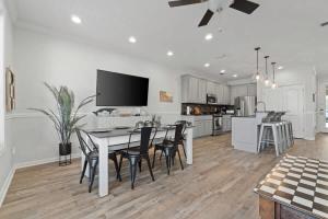 a kitchen and dining room with a table and chairs at Panama City Beach Home - Few steps from the shores in Panama City Beach