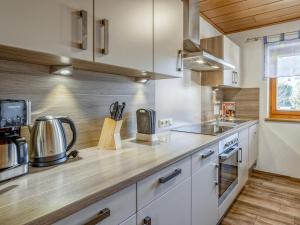 a kitchen with white cabinets and a counter top at Gästehaus Staffner in Sonnberg