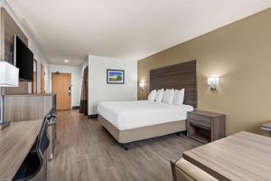 a hotel room with a bed and a desk at Best Western Plus Caldwell Inn & Suites in Caldwell