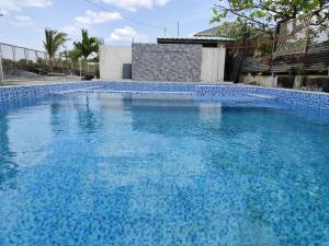a large blue swimming pool with blue water at Calishores Beachfront Resort in Morong