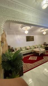 a living room with a couch and a table at Marrakech héberg in Marrakesh
