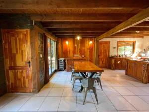 a large kitchen with a wooden table and chairs at Cheerful Santa Juana Cabin in Santa Juana