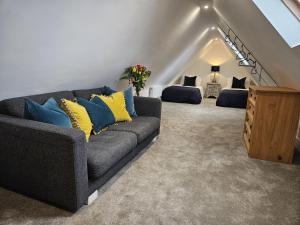 a living room with a couch and two beds at The Lodge in Wadhurst