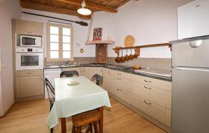 a kitchen with a table and a small table with chairs at 4 Bedroom Amazing Home In Cagnano in Cagnano