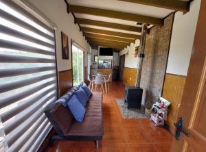 a living room with a couch and a table at Cabaña privada con acceso a playa in Quilquico