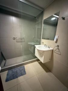 a bathroom with a shower and a sink and a mirror at Departamento 3 Habitaciones Zona Cincuentenario in Formosa +19 photos
