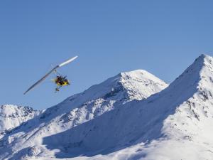 un skieur est en l'air sur une montagne enneigée dans l'établissement Apartment with balcony for 6 people, à Val Cenis