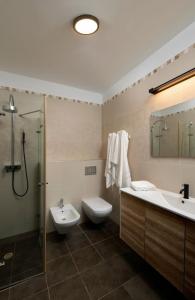 a bathroom with a sink and a toilet and a shower at Lovely 3 Bedroom Mini Penthouse on 30th Floor in Netanya