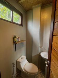 a bathroom with a toilet and a sink at Matam-is Cafe & Homestay in General Luna