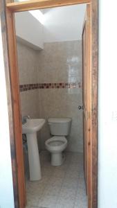 a bathroom with a toilet and a sink at MI CASA EN TEPOZTLAn in Tepoztlán