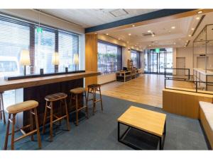 a lobby with a bar and some chairs and tables at The One Five Fukuoka Tenjin - Vacation STAY 40121v in Fukuoka