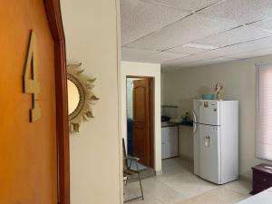 a kitchen with a white refrigerator in a room at casa MH - rodadero in Gaira