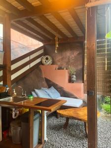 a outdoor kitchen with a table and a sink at Suite au milieu des arbres in Punaauia