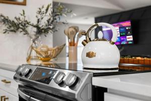 a white tea kettle sitting on top of a stove at Spacious 6 Bed House Pet Friendly AFB in San Antonio