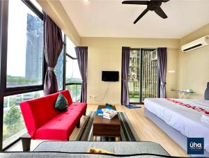 a hotel room with a red couch and a large window at Austin Cube 8 Teens by RR JBcity in Johor Bahru
