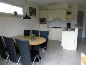 a kitchen and dining room with a table and chairs at Holiday Home in Netherlands with Private Garden in Plasmolen