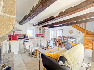 a living room with a couch and a table at Gîte Indépendant à Kervignac, 6 Couchages, Havre de Paix, Parking - FR-1-349-229 in Kervignac +13 photos