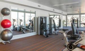 a gym with several treadmills and elliptical machines at A-Class Highland 2 Bed Apt in Hollywood CA with FREE PARKING in Los Angeles
