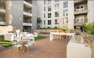a patio with a table and chairs and a building at A-Class Highland 2 Bed Apt in Hollywood CA with FREE PARKING in Los Angeles