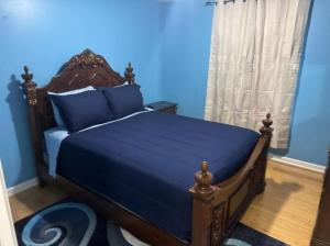 a blue bedroom with a bed with blue sheets at La Vergne hottub hospital mancave 75in Tv in La Vergne