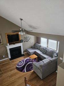 a living room with a couch and a fireplace at La Vergne hottub hospital mancave 75in Tv in La Vergne