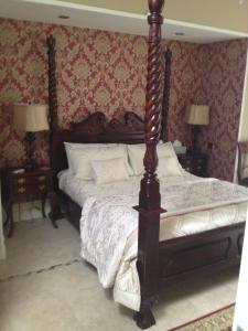 a bedroom with a bed with a wooden post at Riverside Lodge in Carlingford