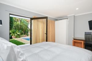 a bedroom with a bed and a large window at Private, Cosy and Stylish Stay at Nest24 Evans Park in Johannesburg +11 photos