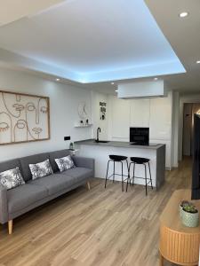 a living room with a couch and a kitchen at DreamSea by BahiaMarCanarias in La Estrella