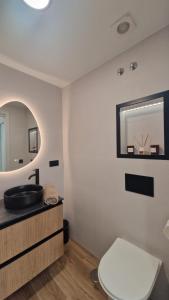 a bathroom with a sink and a toilet and a mirror at DreamSea by BahiaMarCanarias in La Estrella +23 photos
