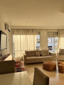 a living room with a couch and a television at Maison azur in Tunis