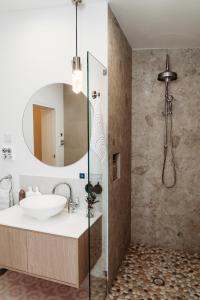a bathroom with a sink and a mirror at Hollyberry House in Cooma