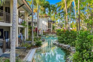 an image of a pool at a resort with palm trees at The Oasis at Temple - A Rooftop Resort Retreat in Port Douglas