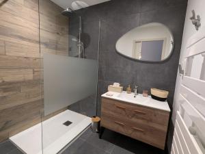 a bathroom with a sink and a mirror at Maison conviviale avec terrasse privée à Sanchey - FR-1-589-800 in Sanchey