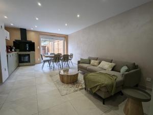 a living room with a couch and a table at Maison conviviale avec terrasse privée à Sanchey - FR-1-589-800 in Sanchey