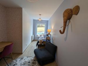 a living room with a stuffed elephant on the wall at Maison conviviale avec terrasse privée à Sanchey - FR-1-589-800 in Sanchey +27 photos