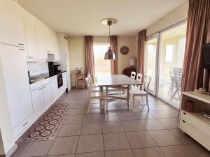 a kitchen and dining room with a table and chairs at Bel Appartement RDC avec Wifi et Parking, 2 Chambres - FR-1-675-47 in Wimereux +2 photos