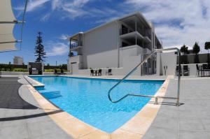 a swimming pool in front of a building at Rockingham Waterfront at Nautilus in Rockingham