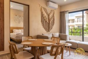 a living room with a table and a couch at Xunik Tulum 205 1BR Condo in Tulum