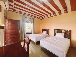Postel nebo postele na pokoji v ubytování Aloha Guest House Nias